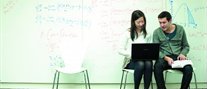Students in front of whiteboard.