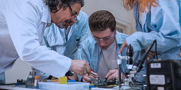 Students of Department of Electrical and Electronic Engineering  in a laboratory intently focused on intricate electronic components.