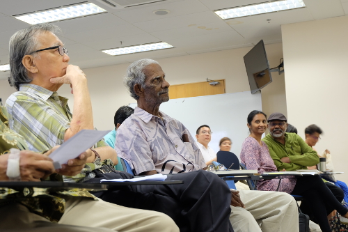 KS Maniam listening to a reader