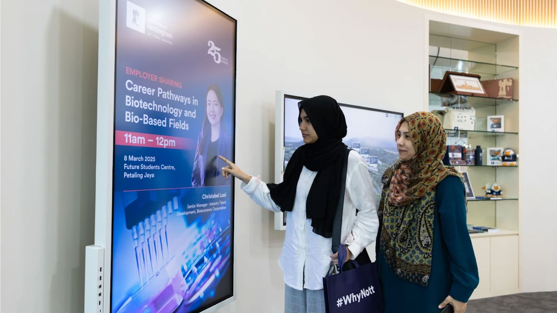 Prospective students interacting with a digital screen at the Future Students Centre at University of Nottingham Malaysia