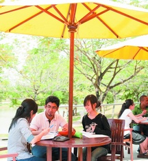Groups of undergraduate students talking in the Student Association Cafe at The University of Nottingham Malaysia campus