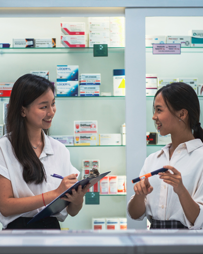 two students at the pharmacy counter