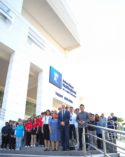 UNM staff and students taking picture at trent building