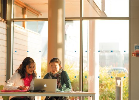 Two students working on a laptop on University Park Campus